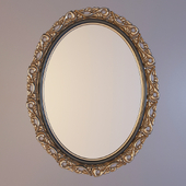 oval mirror in a carved frame