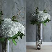 White hydrandeas in tall vase with willow branches
