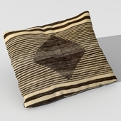 Pillow upholstered with Kuba fabric
