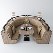 Полукруглый диван с столом и декором