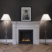 The fireplace is marble with a biotope, floor lamps and a picture.