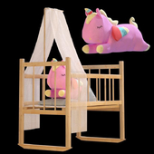 Pink unicorn in toy bed