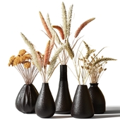 Set of bouquets of dried flowers in black clay vases