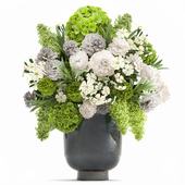 A lush bouquet of green flowers in a beautiful metal vase with Hydrangeas, Peonies, spring flowers, Lilac. 112.