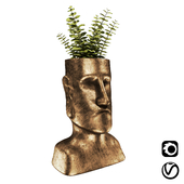 Easter Island bronze sculpture with plant