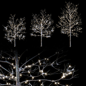 Trees in the snow with a luminous garland