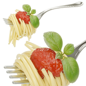 Spaghetti on a fork with ketchup and basil
