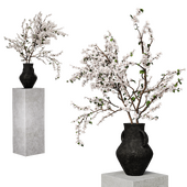 Apple tree branch in a decorative vase on a stand