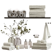 Decorative set for the bathroom with towels and branches in a vase