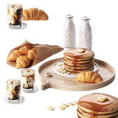 Breakfast with pancakes and croissants with coffee