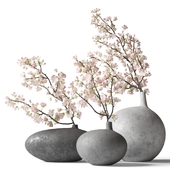Flowering branches in teardrop-shaped ceramic vases