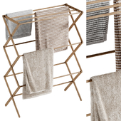 Wooden towel rack with hanging towels